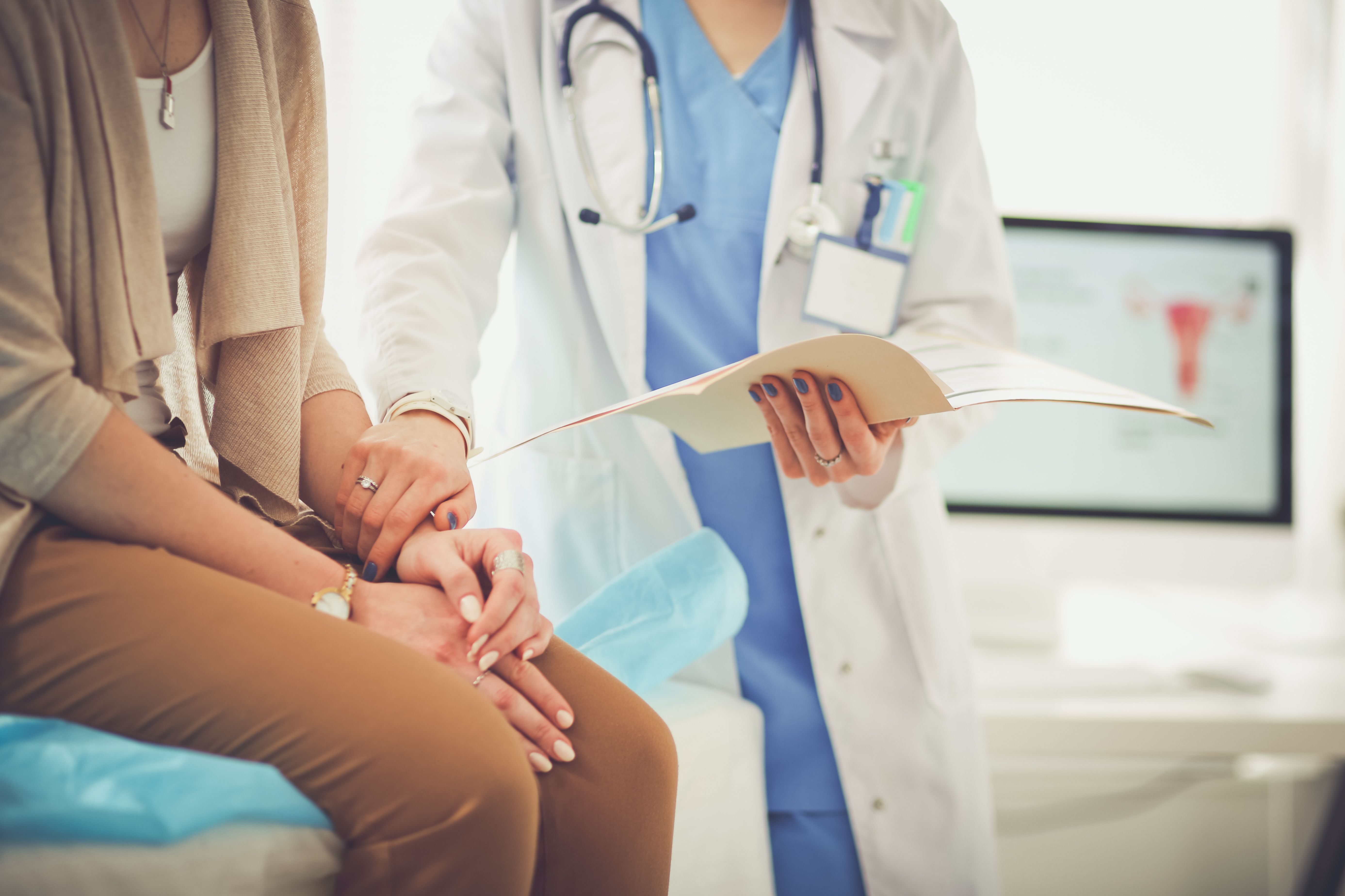 Women Doctor holding patient hand